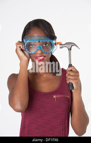 Femme portant des lunettes holding a hammer Banque D'Images