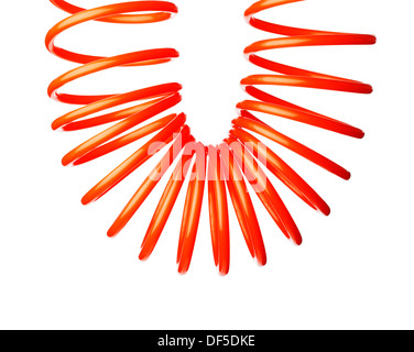 Spirale rouge fine orange flexible d'air utilisé pour outils pneumatiques. Banque D'Images