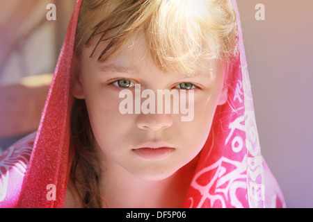 Closeup portrait of calm blonde Young little girl in red shawl Banque D'Images