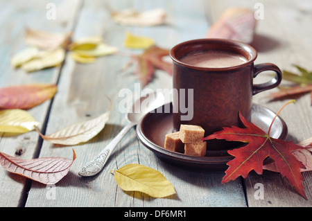 Tasse de chocolat chaud avec du sucre brun sur fond de bois Banque D'Images