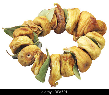 Les figues séchées sur les feuilles vertes isolé sur fond blanc Banque D'Images