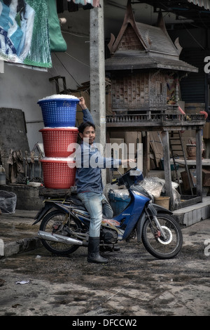 Livreur de glace avec moto chargée dans un marché thaïlandais. S. E. Asie Thaïlande Banque D'Images