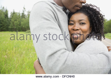 Portrait of woman hugging mari outdoors