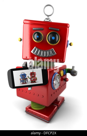 Happy vintage toy robot with smartphone Banque D'Images