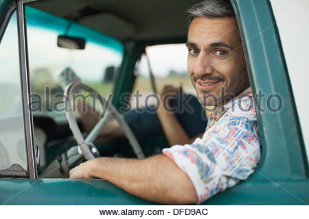 Portrait of mid adult man sitting in pick-up Truck