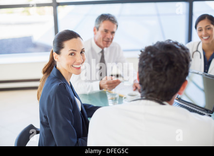 Businesswoman smiling in meeting Banque D'Images