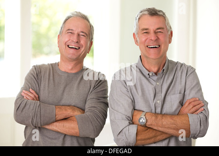 Portrait de senior men laughing with arms crossed Banque D'Images