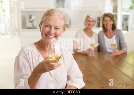 Portrait of smiling senior women drinking white wine Banque D'Images