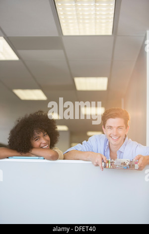 Portrait of smiling business people holding circuit board in office Banque D'Images