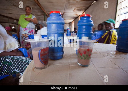 Les parieurs dans un pub avec des bouteilles de 'Kibuku' un alcool bon marché vendus dans des bouteilles en plastique, Dar es Salaam, Tanzanie Banque D'Images