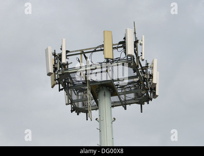 Haut d'une tour de téléphonie cellulaire contre un ciel gris. Banque D'Images