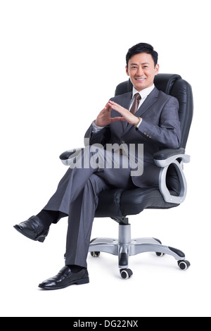 Gestionnaire maturité sitting in chair Banque D'Images