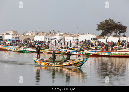 Sénégal, Saint Louis. Les pêcheurs vers la mer tandis que les camions réfrigérés jusqu'à la ligne de faire des captures des pêcheurs aux marchés intérieurs. Banque D'Images