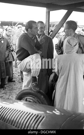 Harry Schell et Baron de Graffenried bavarder dans le paddock à Goodwood, le 30 septembre 1950. Banque D'Images