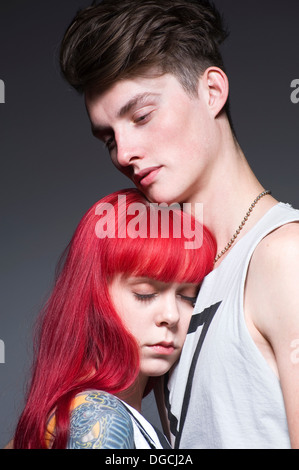 Young couple embracing in studio Banque D'Images