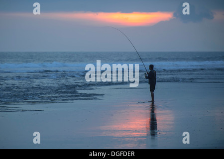 Pêcheur debout sur la plage, Kerambitan, Bali, Indonésie Banque D'Images