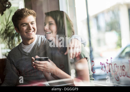 Jeune couple partager coffee in cafe Banque D'Images