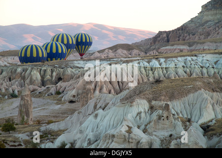 Montgolfières volant entre les rochers sur la Cappadoce Turquie Banque D'Images