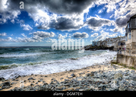 Ciel bleu nuages sombres et Rocky beach St Ives Cornwall England dans HDR Banque D'Images