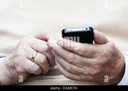 Vieil homme tenant un smartphone dans la main Banque D'Images