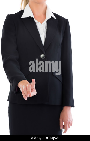 Mid section de blond businesswoman pointing at camera Banque D'Images