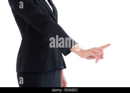 Mid section of young businesswoman pointing Banque D'Images