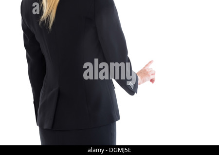 Mid section de blond businesswoman pointing Banque D'Images