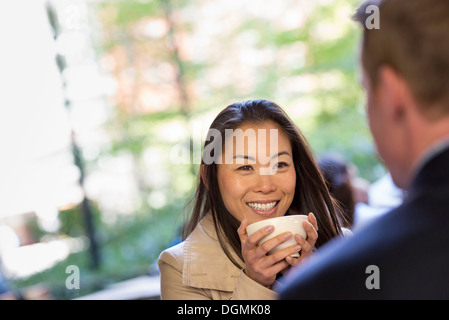 Un homme et une femme assis dans un café. Banque D'Images