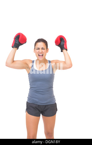 Heureux sporty brunette wearing red boxing gloves Banque D'Images