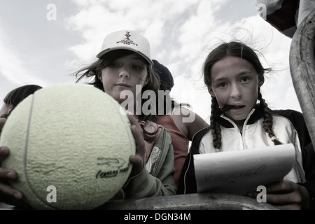 Les jeunes amateurs de tennis vous attendent pour les joueurs de venir pour leur demander des autographes dans un tournoi local à Majorque, Espagne Banque D'Images