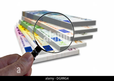 Pile de billets sous une loupe, l'image symbolique, l'observation de l'euro Banque D'Images