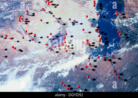 Une vue satellite de la Terre avec picots droits à divers endroits, digital composite Banque D'Images
