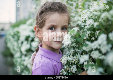 Une jeune fille fleurs odorantes Banque D'Images