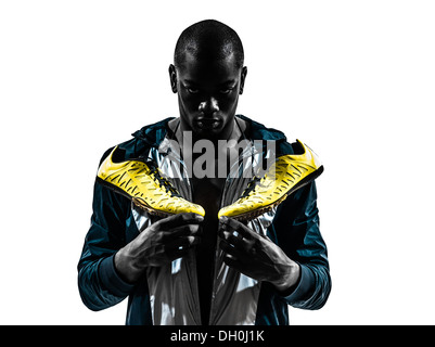 Un homme africain runner sprinter jogger posant debout en silhouette studio isolé sur fond blanc Banque D'Images