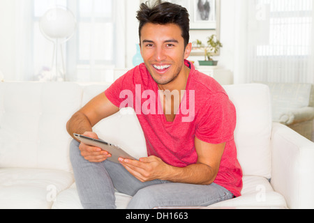 Mixed Race teenager using digital tablet Banque D'Images