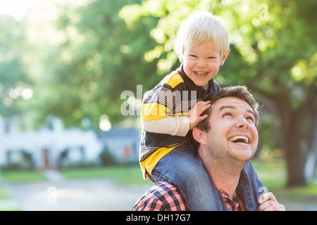Woman carrying son on shoulders