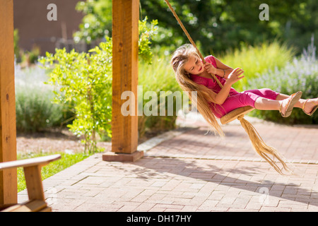 Caucasian girl on swing Banque D'Images