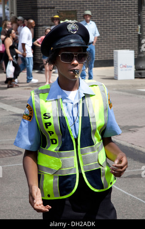 Black police woman calmement diriger la circulation. Grand Old Day Festival St Paul Minnesota MN USA Banque D'Images