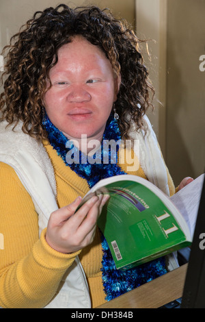 L'Afrique du Sud, Cape Town. Les déficients visuels Albino Student Holding Cahier de l'élève. Athlone École pour les aveugles. Banque D'Images