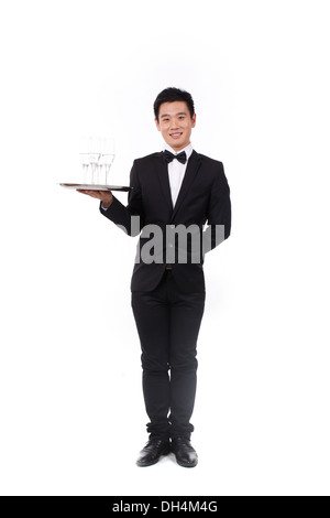 Man in tuxedo holding a plate Banque D'Images
