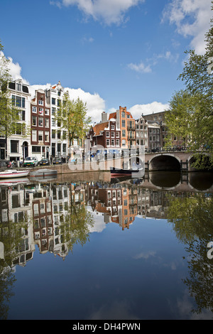 Les Pays-Bas, Amsterdam, reflet de maisons au bord du canal, péniches du canal Singel. Petit bateau. Site du patrimoine mondial de l'Unesco Banque D'Images