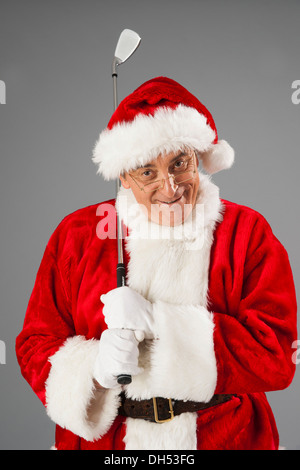 Santa Claus holding a golf club Banque D'Images