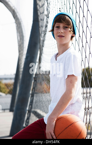 Cool boy holding a basketball Banque D'Images