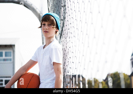 Cool boy holding a basketball Banque D'Images