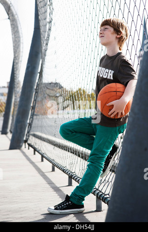 Cool boy holding a basketball Banque D'Images