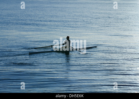 Un rameur dans un bateau skiff Banque D'Images