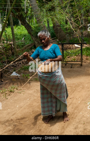 Femme Fabrication de cordes à partir de la noix de coco, Kochi, Kerala, Inde, Asie Banque D'Images