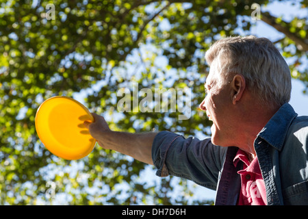 Homme mûr de la capture d'un disque volant Banque D'Images