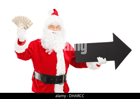 Smiling Santa Claus holding big black flèche orientée vers la droite et en US dollars Banque D'Images