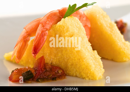 Les tranches de polenta avec les crevettes cuites et sauce hogao colombien Banque D'Images